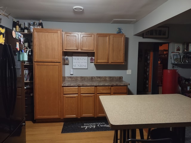 kitchen featuring black fridge and light wood-type flooring