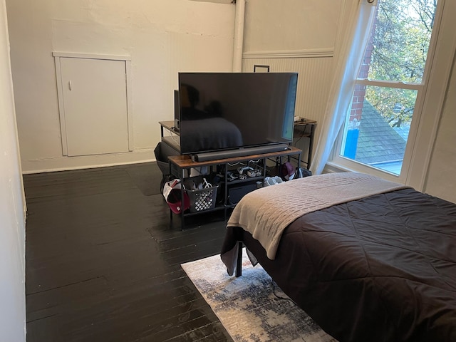 bedroom with dark wood-type flooring