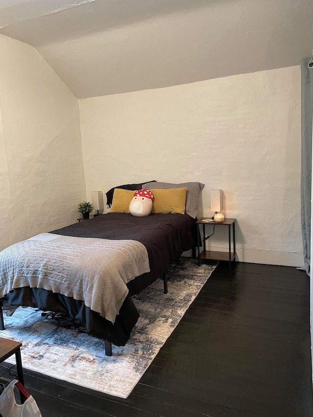 bedroom with hardwood / wood-style flooring and vaulted ceiling