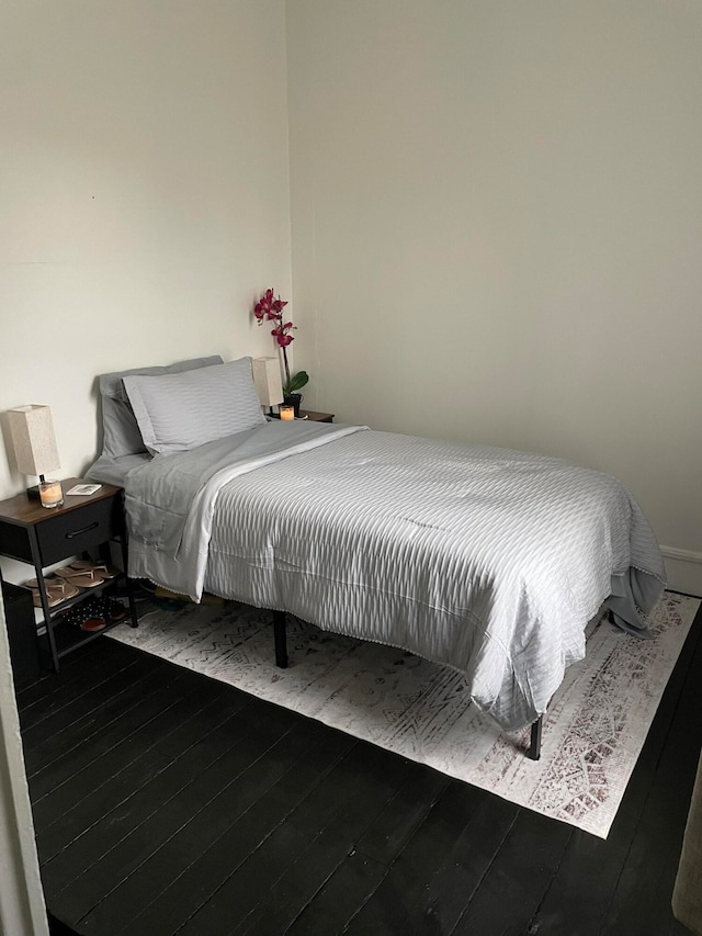 bedroom with hardwood / wood-style flooring