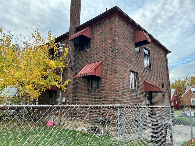 12644 Corbett St, Detroit, MI 48213 - view of home's exterior with brick siding and a chimney