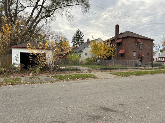 view of side of property with an outdoor structure and a garage