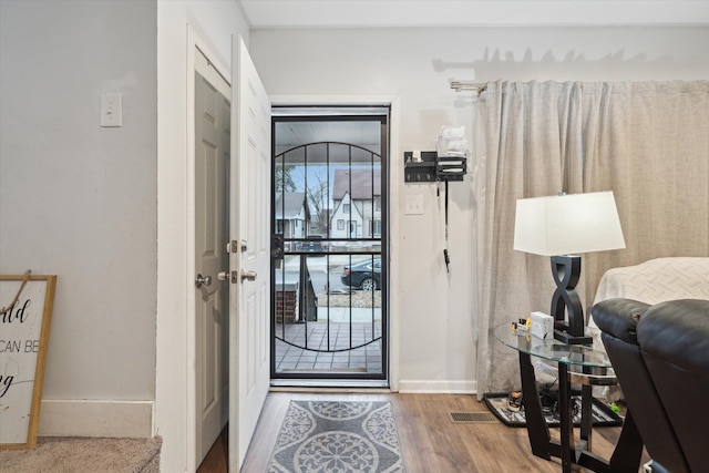 foyer entrance featuring hardwood / wood-style flooring and a healthy amount of sunlight