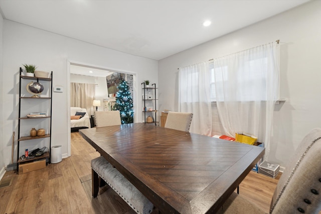 dining space with light hardwood / wood-style flooring