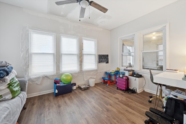 home office featuring wood-type flooring and ceiling fan