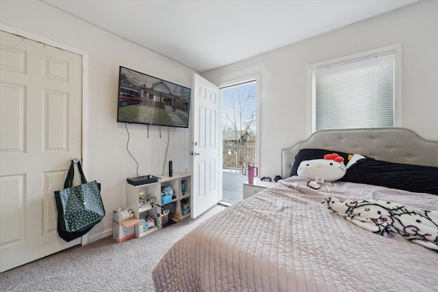 bedroom with carpet flooring and access to exterior