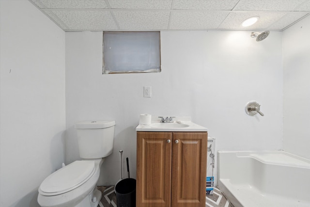 bathroom with vanity, toilet, and a drop ceiling