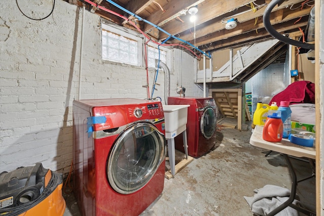 clothes washing area featuring separate washer and dryer