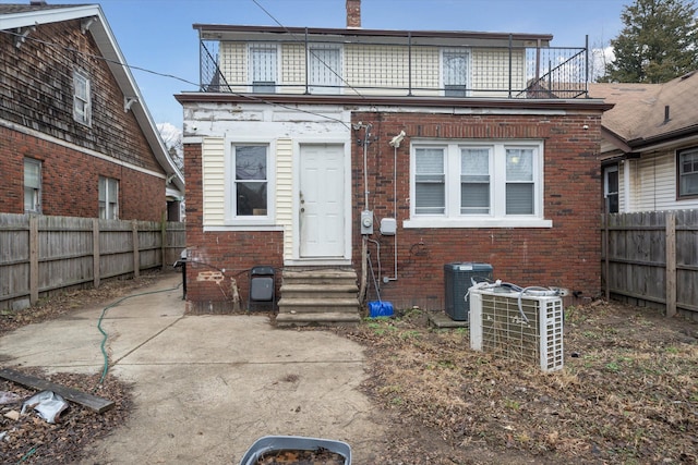 rear view of house with a balcony and central air condition unit