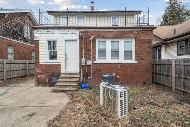 back of property with a balcony and central AC unit