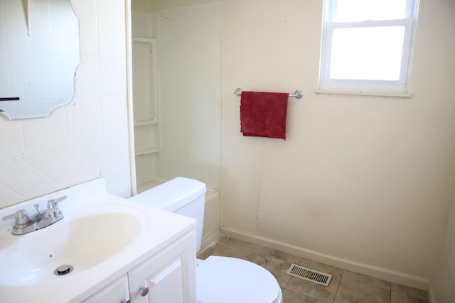 bathroom with tile patterned flooring, vanity, and toilet