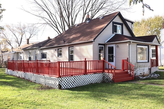 back of property featuring a lawn and a wooden deck