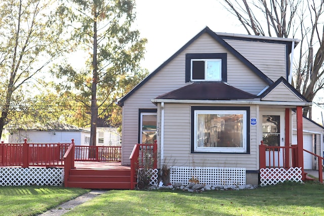 back of house featuring a wooden deck and a yard