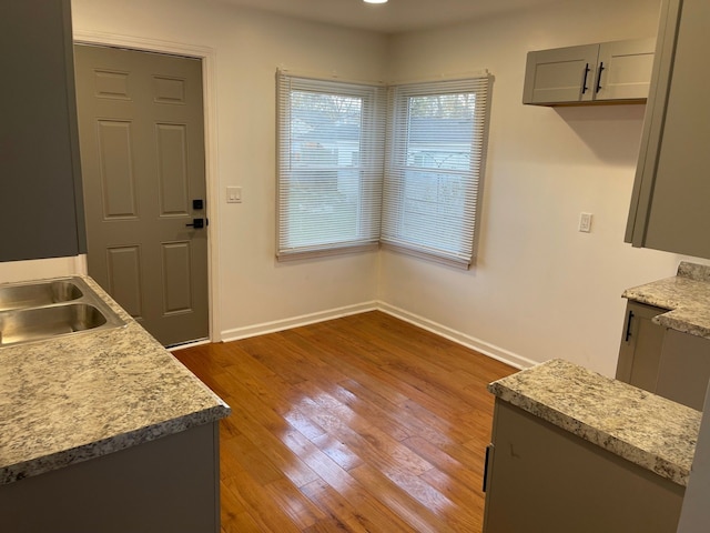 dining room with wood-type flooring and sink