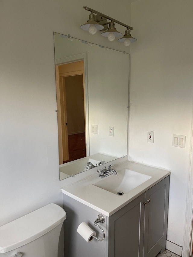 bathroom featuring vanity and toilet