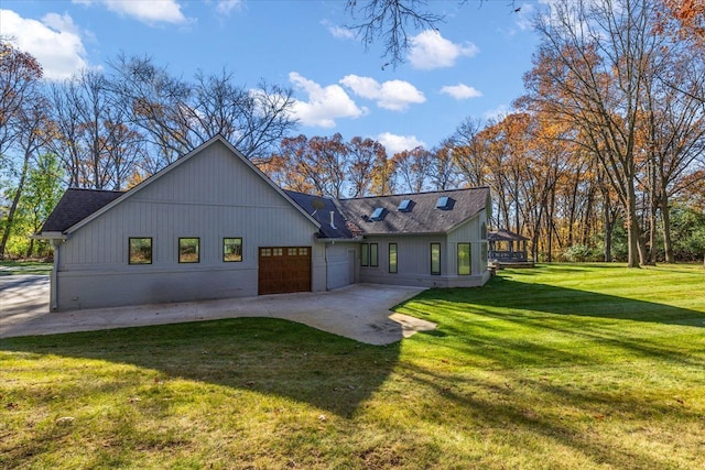 view of front facade with a patio, a front yard, and a garage