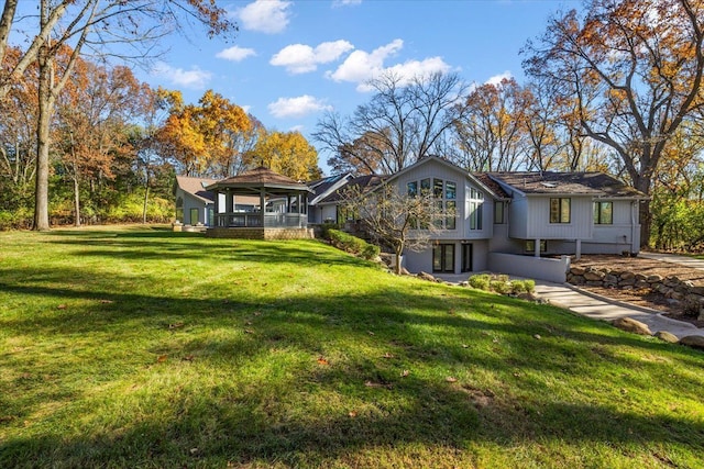 view of front of home with a gazebo and a front lawn