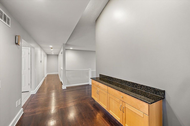 corridor with dark hardwood / wood-style floors