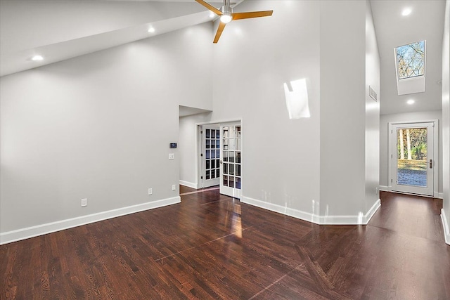 unfurnished room with french doors, dark hardwood / wood-style floors, high vaulted ceiling, and ceiling fan