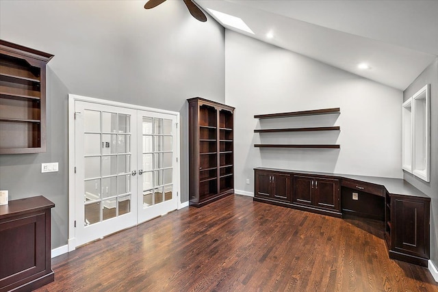 unfurnished office featuring ceiling fan, dark hardwood / wood-style flooring, built in desk, and vaulted ceiling