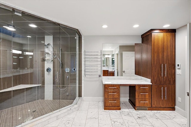 bathroom featuring vanity and a shower with shower door