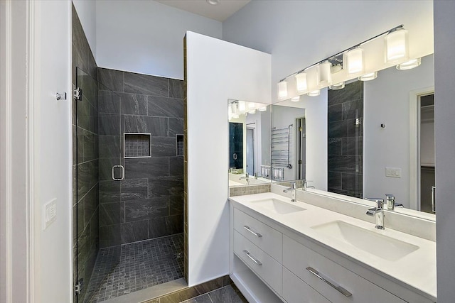 bathroom with vanity and a shower with door