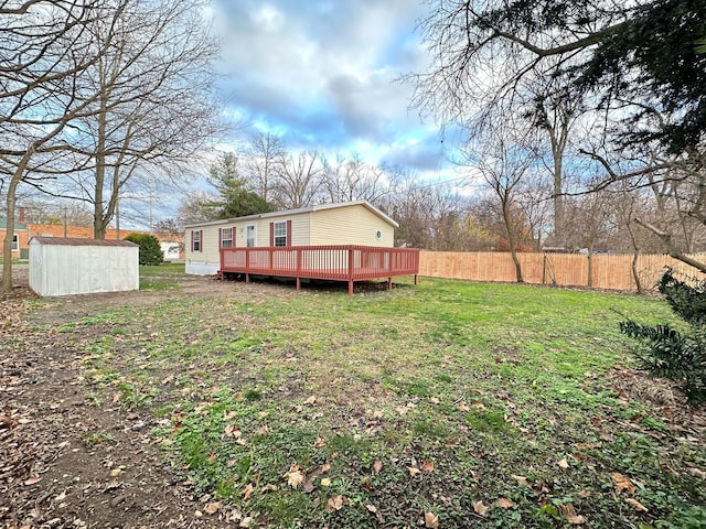 view of yard featuring a storage shed and a deck