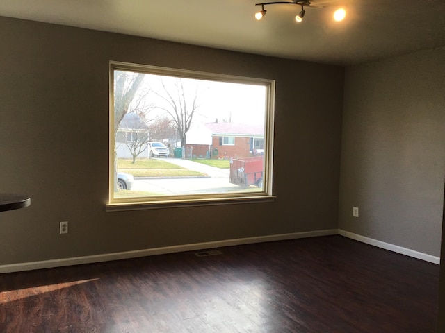 empty room with dark hardwood / wood-style floors