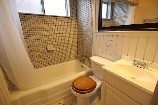 full bathroom with tile patterned floors, shower / tub combo with curtain, vanity, and toilet