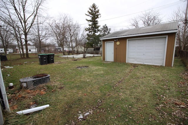 view of yard featuring a garage and an outdoor structure