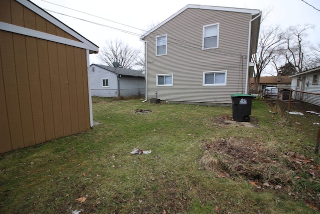 rear view of house featuring a yard