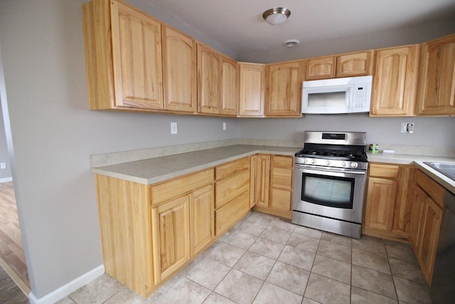 16117 Jackson St, Taylor, MI 48180 - kitchen featuring light brown cabinets, white appliances, and light tile patterned floors