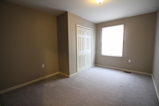16117 Jackson St, Taylor, MI 48180 - unfurnished bedroom with a closet, baseboards, and carpet flooring