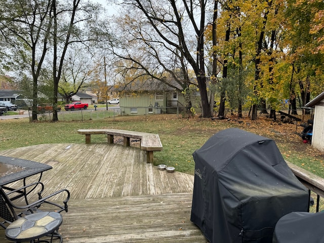 deck with area for grilling and a yard