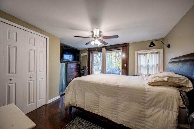 bedroom featuring ceiling fan, dark wood-type flooring, and a closet