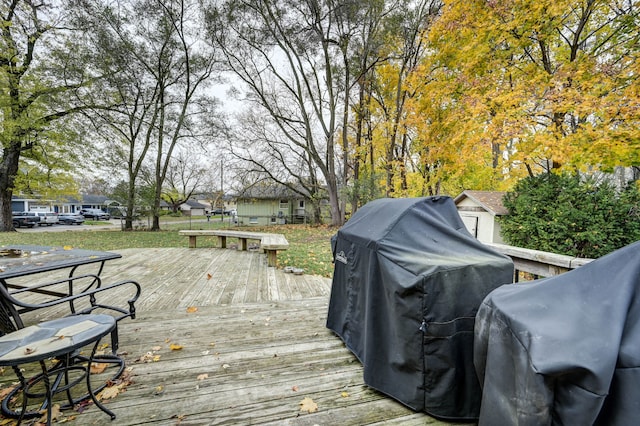 wooden deck with a grill