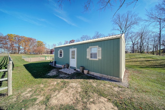 view of outbuilding featuring a lawn