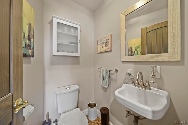 bathroom featuring sink and toilet