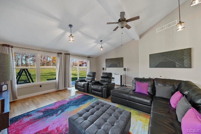 living room with hardwood / wood-style flooring, ceiling fan, and lofted ceiling