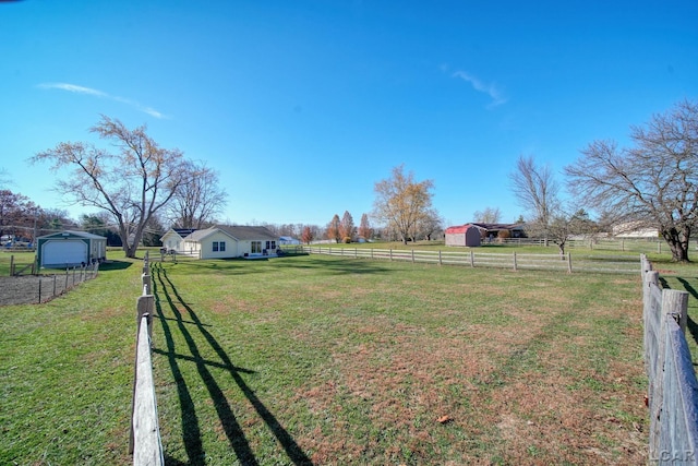 view of yard with an outbuilding and a rural view