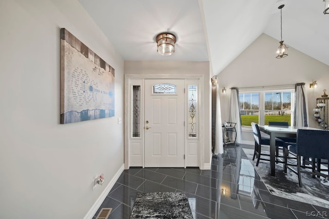 tiled foyer featuring high vaulted ceiling