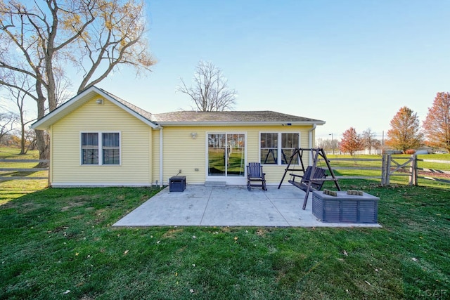 rear view of house with a yard and a patio area