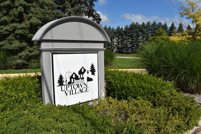 community / neighborhood sign with a lawn