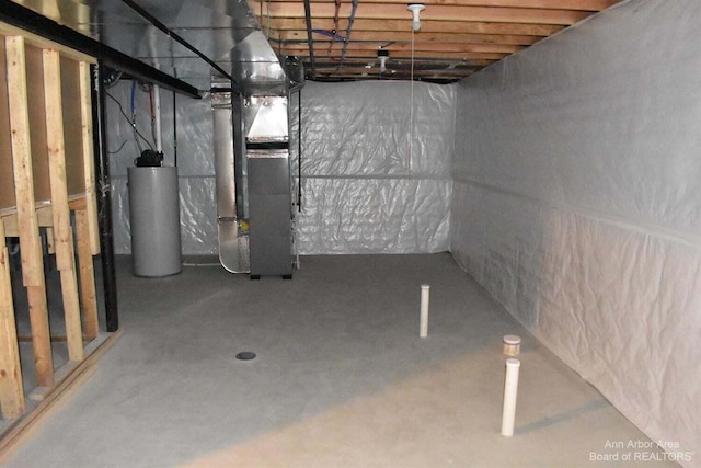 basement with water heater and heating unit