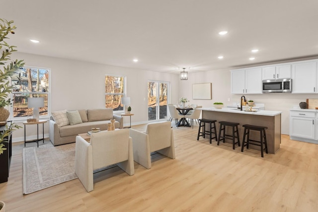 733 Jefferson Ln, Milan, MI 48160 - living room featuring light wood-style flooring and recessed lighting