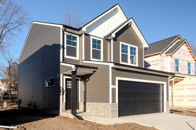 733 Jefferson Ln, Milan, MI 48160 - view of front of home with an attached garage, driveway, board and batten siding, and stone siding
