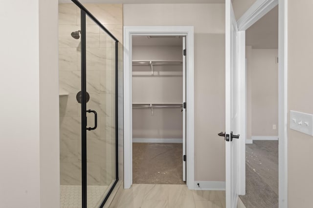 733 Jefferson Ln, Milan, MI 48160 - bathroom with a shower stall, a spacious closet, and baseboards