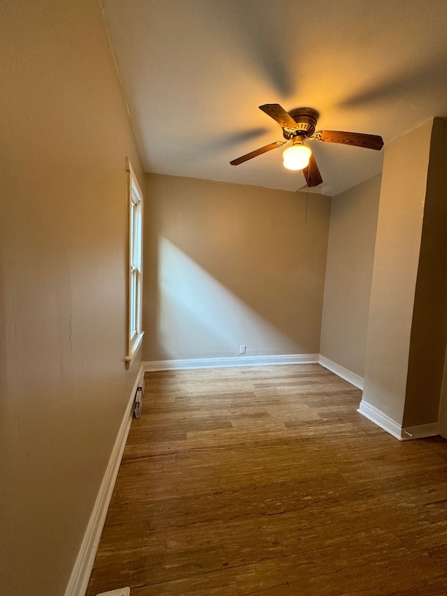 unfurnished room featuring ceiling fan and hardwood / wood-style flooring