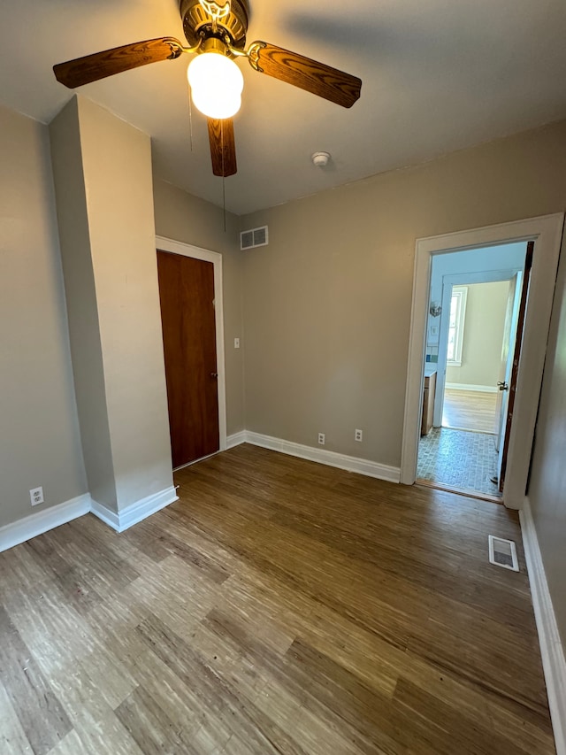 unfurnished room with ceiling fan and wood-type flooring