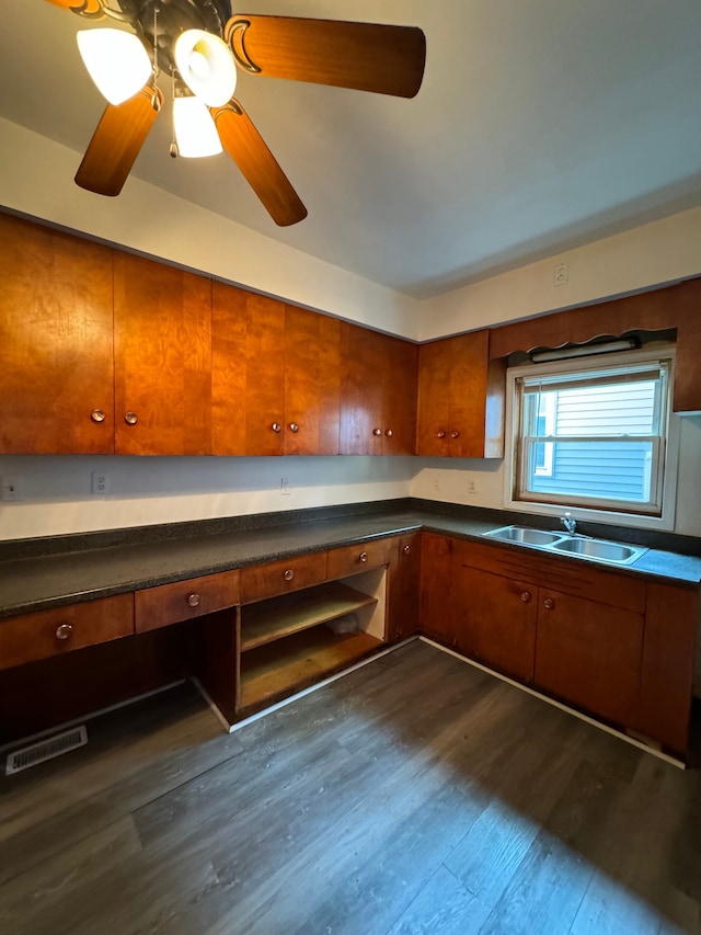 kitchen featuring ceiling fan, sink, and dark wood-type flooring